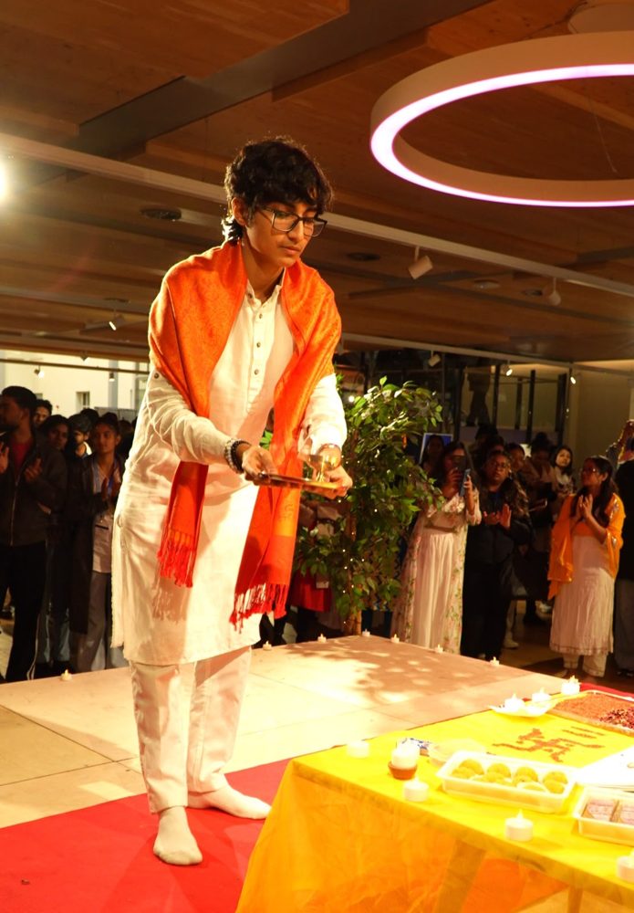 Swayam J. Shah performing aarti at the University of Greenwich Diwali celebration as Hindu Society President