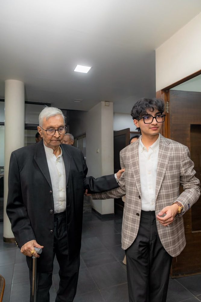 Swayam J. Shah walking with his grandfather, the founder of Fine Cast Group, in Anand